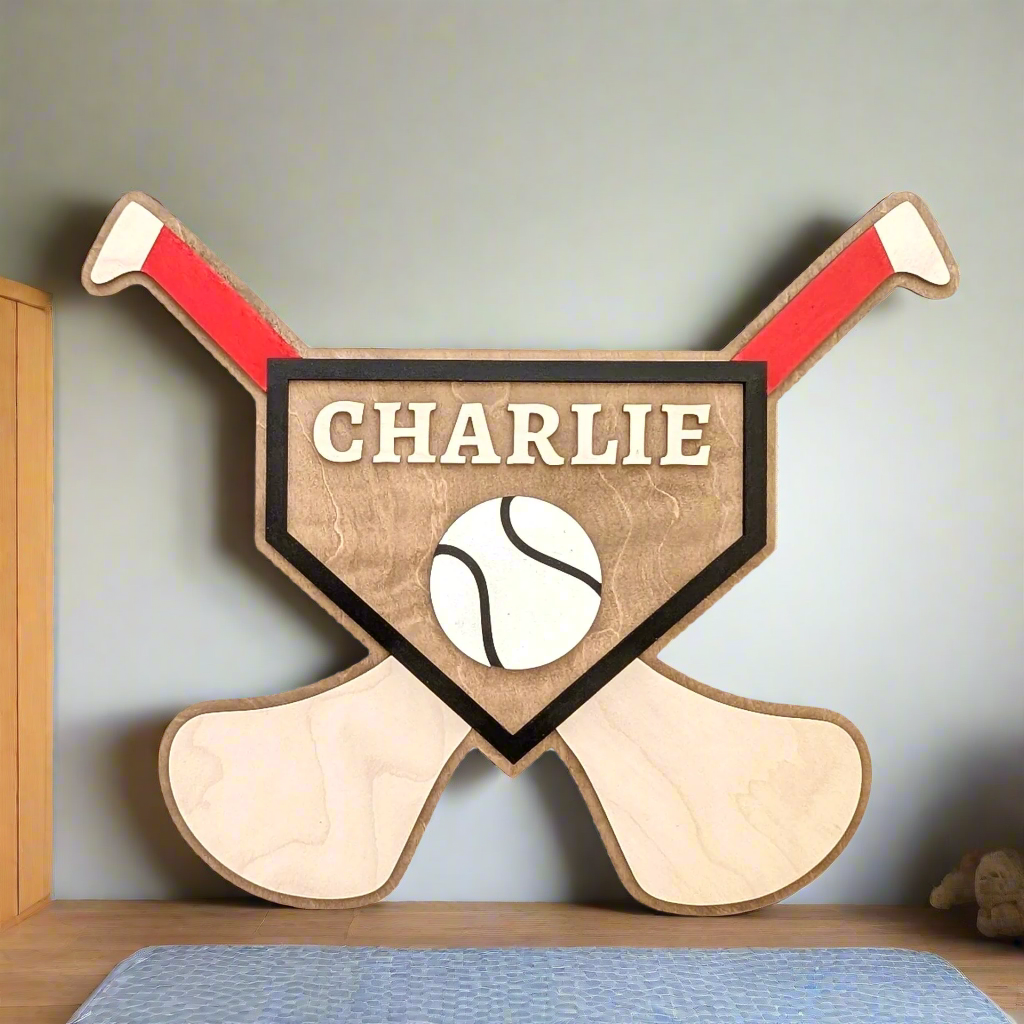 A personalised wall sign with crossed hurleys and a sliotar