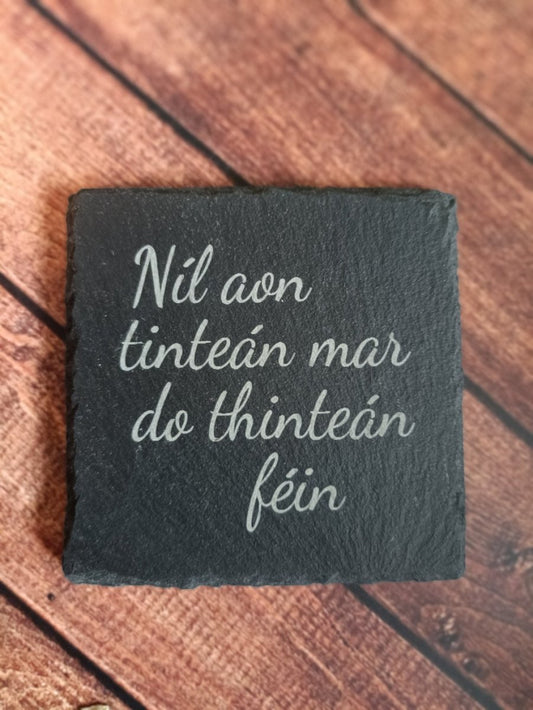 Irish phrases on slate coaster. Nil aon tintean mar de thintean fein.
