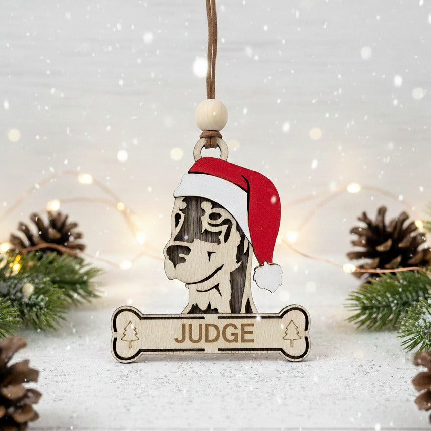 Decorative wooden Christmas ornament with a dobermann wearing a Santa hat