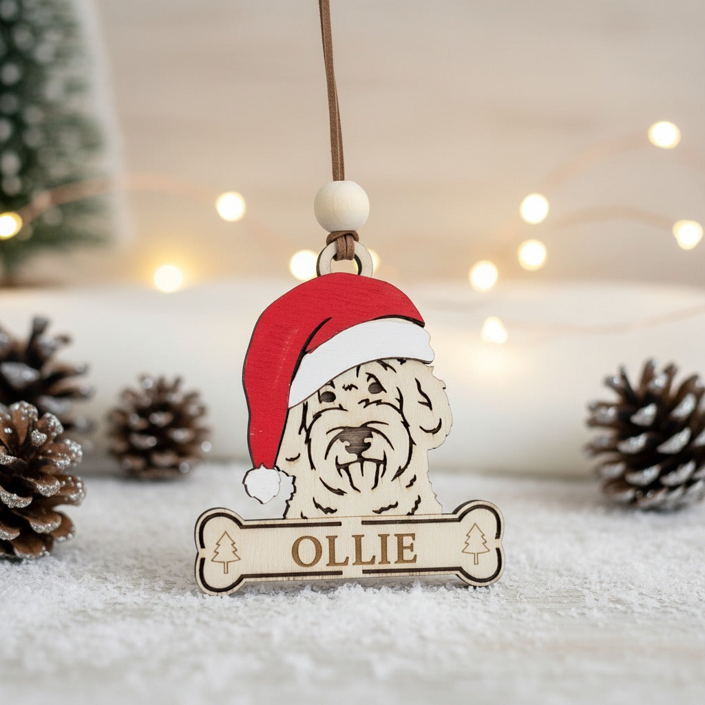 Wooden ornament of a Goldendoodle dog wearing a santa hat