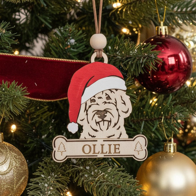 Goldendoodle Christmas tree ornament of a dog wearing a Santa hat