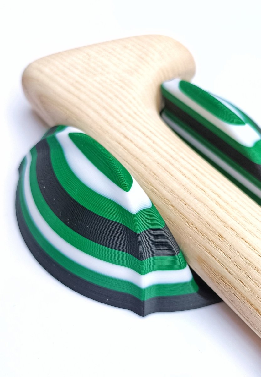 A wall mount hurley holder in green white and black